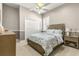 Comfortable bedroom featuring neutral decor, ceiling fan, and large window with plantation shutters at 10724 Cory Lake Dr, Tampa, FL 33647