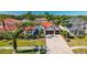 Beautiful two-story home with a red tile roof, three-car garage, and well-manicured landscaping at 10724 Cory Lake Dr, Tampa, FL 33647