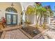 Inviting front entrance with double doors, decorative columns, and a brick-paved walkway at 10724 Cory Lake Dr, Tampa, FL 33647