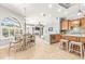 Bright eat-in kitchen features stainless appliances, tile floors, a breakfast bar, and seamless flow to the living space at 10724 Cory Lake Dr, Tampa, FL 33647
