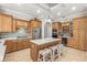 Spacious kitchen with custom cabinetry, a large center island, stainless steel appliances, and a wine fridge at 10724 Cory Lake Dr, Tampa, FL 33647