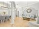 Open-concept living and dining area with tile floors, elegant columns, and lots of natural light at 10724 Cory Lake Dr, Tampa, FL 33647
