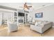 Cozy living room features a stone fireplace, a ceiling fan, recessed lighting, and neutral tones throughout at 10724 Cory Lake Dr, Tampa, FL 33647