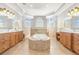 Large main bathroom features dual vanities, a makeup station, tiled floors, and a large soaking tub at 10724 Cory Lake Dr, Tampa, FL 33647