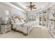 Spacious main bedroom features a tray ceiling, ceiling fan, and private access to the pool area at 10724 Cory Lake Dr, Tampa, FL 33647