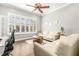 Bright office space with two sofas, plantation shutters, and a glass door at 10724 Cory Lake Dr, Tampa, FL 33647