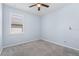 The well lit bedroom with plush carpeting offers a serene retreat with ample natural light from a shaded window at 11016 Kiskadee Cir, New Port Richey, FL 34654