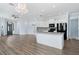 An open floor plan that showcases a gourmet kitchen with stainless steel appliances and luxury finishes at 11016 Kiskadee Cir, New Port Richey, FL 34654
