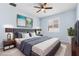 Virtually staged main bedroom with a large bed, stylish decor, and window with shutters at 11016 Kiskadee Cir, New Port Richey, FL 34654