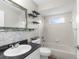 Bathroom featuring a toilet, bathtub and shower, granite countertop, and a decorative mirror at 11225 Flower Ave, Weeki Wachee, FL 34613