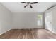 Bedroom featuring hardwood floors, neutral paint, a ceiling fan, and a window at 11225 Flower Ave, Weeki Wachee, FL 34613