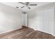 Well-lit bedroom featuring hardwood floors, neutral paint, a closet, and a ceiling fan at 11225 Flower Ave, Weeki Wachee, FL 34613