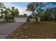 Charming single-Gathering home with a two car garage, mature landscaping, and a long driveway at 11225 Flower Ave, Weeki Wachee, FL 34613
