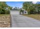 Beautiful single-story house with a two-car garage and extended driveway provides ample parking space for residents and guests at 11225 Flower Ave, Weeki Wachee, FL 34613