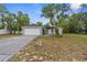 Charming single-story home with neutral paint, an attached two-car garage, and a well-manicured front yard at 11225 Flower Ave, Weeki Wachee, FL 34613