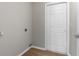Laundry room with hardwood floors and a white paneled door at 11225 Flower Ave, Weeki Wachee, FL 34613