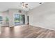 Bright living space with vaulted ceiling and wood-look floors leads to the outdoor screened patio for added relaxation at 11225 Flower Ave, Weeki Wachee, FL 34613