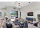 Cozy living room showcasing vaulted ceilings, comfortable seating, a stylish area rug, and a mounted TV at 11225 Flower Ave, Weeki Wachee, FL 34613
