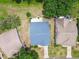 An aerial view showcases the home's roof, driveway, and the surrounding landscaping and lawns at 11628 Aspenwood Dr, New Port Richey, FL 34654