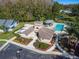 Aerial view of community center, pool, and surrounding landscaping and trees at 11628 Aspenwood Dr, New Port Richey, FL 34654