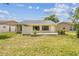 A well-maintained backyard featuring a patio and healthy green lawn at 11628 Aspenwood Dr, New Port Richey, FL 34654