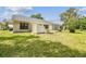 Spacious backyard featuring a well-maintained lawn and lush landscaping at 11628 Aspenwood Dr, New Port Richey, FL 34654