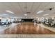 Large community ballroom with hardwood dance floor, chairs and tables at 11628 Aspenwood Dr, New Port Richey, FL 34654