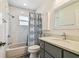 The bathroom features a shower with bathtub, toilet, and grey vanity with white countertop at 11628 Aspenwood Dr, New Port Richey, FL 34654