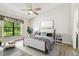 Bright bedroom with large window, ceiling fan, and neutral decor creating a serene space at 11628 Aspenwood Dr, New Port Richey, FL 34654