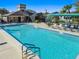 Community pool with lounge chairs, tables, and covered seating areas at 11628 Aspenwood Dr, New Port Richey, FL 34654