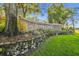 Welcoming Summertree community sign with brick detail, stone accents and a lush landscaped entrance at 11628 Aspenwood Dr, New Port Richey, FL 34654