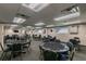 Community game room featuring multiple poker tables, chairs, TV, and clocks at 11628 Aspenwood Dr, New Port Richey, FL 34654