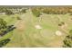 An aerial view of a lush green golf course featuring sand traps and neatly manicured putting greens at 11628 Aspenwood Dr, New Port Richey, FL 34654