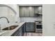 Kitchen featuring stainless steel appliances, gray cabinets, and luxurious marble countertops at 11628 Aspenwood Dr, New Port Richey, FL 34654