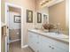 Bathroom featuring double sinks with white cabinets, a toilet room, and neutral wall colors at 11813 Crawford Parrish Ln, Parrish, FL 34219