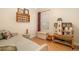 Bedroom featuring a daybed, wood floors, and charming dollhouse at 11813 Crawford Parrish Ln, Parrish, FL 34219