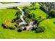 Overhead view of lush community garden featuring manicured greenery, park benches, and winding walkways at 11813 Crawford Parrish Ln, Parrish, FL 34219