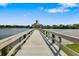 A wooden pier extends into the lake, offering a tranquil escape with beautiful water views at 11813 Crawford Parrish Ln, Parrish, FL 34219