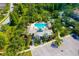 Aerial view of a sparkling community pool with covered seating areas and lush greenery at 11813 Crawford Parrish Ln, Parrish, FL 34219