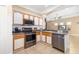 Charming kitchen featuring stainless steel appliances, tile floors, and stylish cabinetry for a modern and functional design at 11813 Crawford Parrish Ln, Parrish, FL 34219