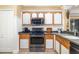 Well-equipped kitchen featuring stainless steel appliances, wood cabinets, and a functional layout at 11813 Crawford Parrish Ln, Parrish, FL 34219