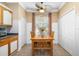 Bright kitchen area with wooden dining table, a window, and white cabinets with wood trim at 11813 Crawford Parrish Ln, Parrish, FL 34219