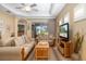 Cozy living room showcasing tile floors, tray ceiling, and comfortable seating, creating an inviting atmosphere at 11813 Crawford Parrish Ln, Parrish, FL 34219
