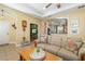 Well-lit living room with tile flooring, open layout, and comfortable sofa arrangement, ideal for relaxation at 11813 Crawford Parrish Ln, Parrish, FL 34219