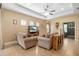 Bright living room showcasing tile floors, tray ceiling, and comfortable seating, creating an inviting atmosphere at 11813 Crawford Parrish Ln, Parrish, FL 34219
