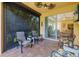 Screened-in paver patio with seating and view into home at 11813 Crawford Parrish Ln, Parrish, FL 34219