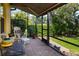 Covered patio with brick pavers features comfortable seating and views of the yard at 11813 Crawford Parrish Ln, Parrish, FL 34219