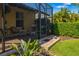 Screened-in paver patio with seating and view of lawn at 11813 Crawford Parrish Ln, Parrish, FL 34219