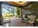 Screened-in paver patio features ample seating and serene outdoor views at 11813 Crawford Parrish Ln, Parrish, FL 34219