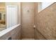 Walk-in shower featuring tiled walls, grab bars, and a showerhead at 11813 Crawford Parrish Ln, Parrish, FL 34219
